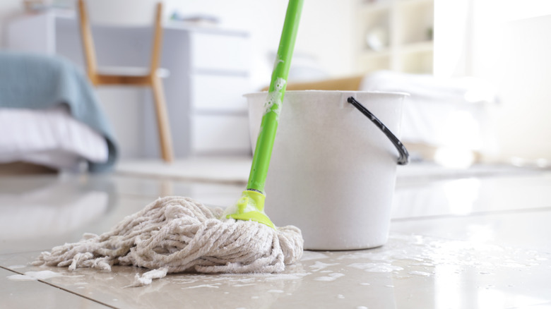 Cleaning floor with a bucket and mop