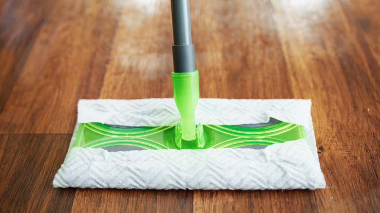 A Swiffer dust mop on a wood floor