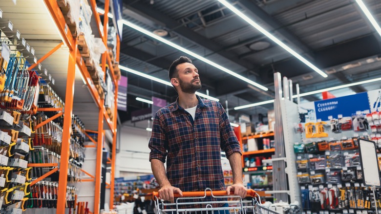 Man pushing cart in home improvement store