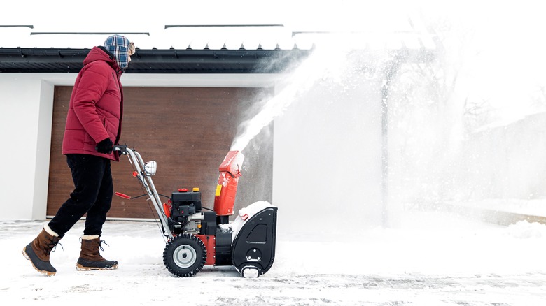 person using a snowblower