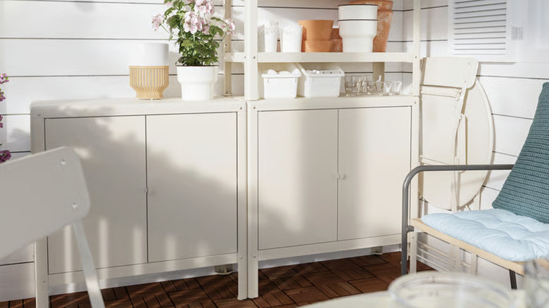 IKEA KOLBJÖRN cabinet on patio holding a variety of content with plants on top