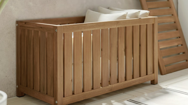 brown IKEA NÄMMARÖ storage box holding white pillows