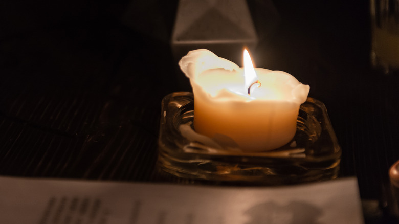 Candle burning in an ashtray