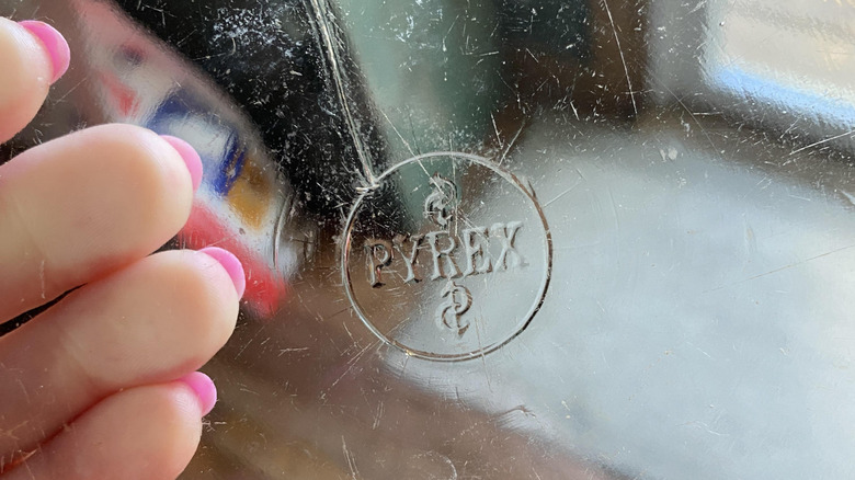 A clear pyrex dish with an old logo