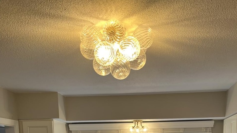 Amazon orb chandelier styled in a hallway