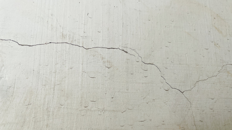 Hairline cracks on a dull wall