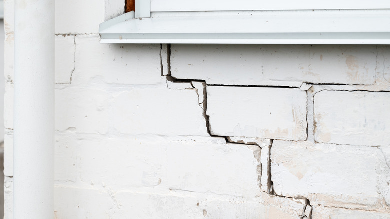 Cracked brick wall under a window