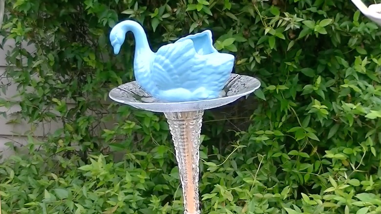 Blue swan vase on a DIY feeder pole and plate