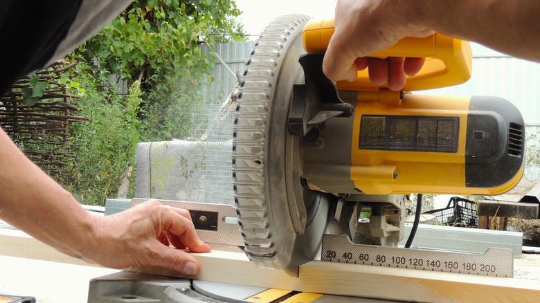 Using a miter saw to cut grooves in a wooden board