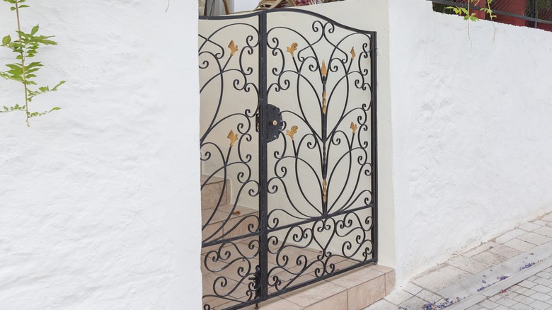 Brass floral accents on a grille gate.