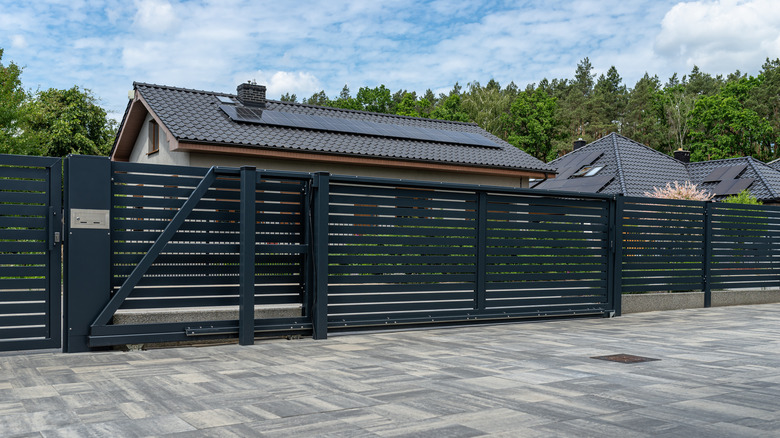 An anthracite colored grille gate in front of a home.