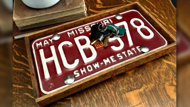 View of a tray made of a license plate and old rulers