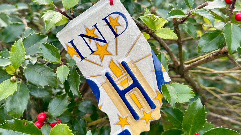 Christmas tree ornament made of license plate cut into the shape of Indiana