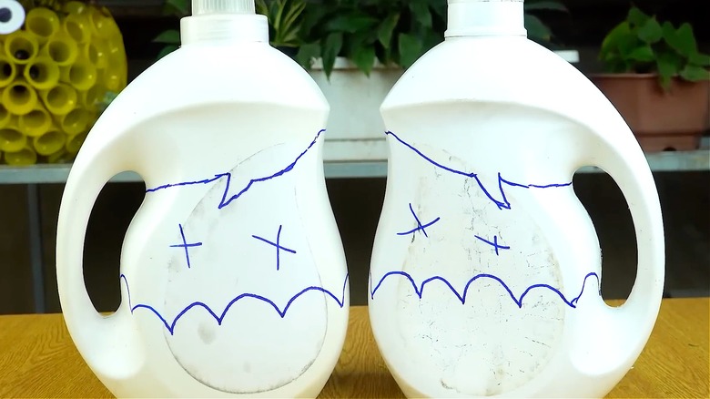 Project's detergent containers with guide lines drawn for cutting