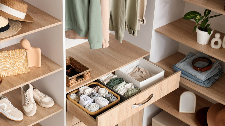 clothing items organized in boxes in drawers