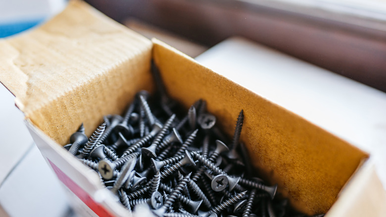 a cardboard box filled with screws