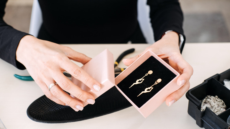 pink gift box holding earrings