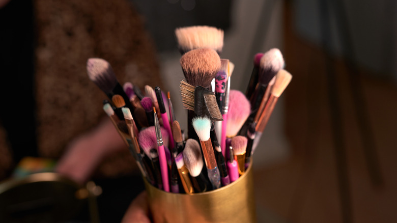 closeup on makeup brushes in container