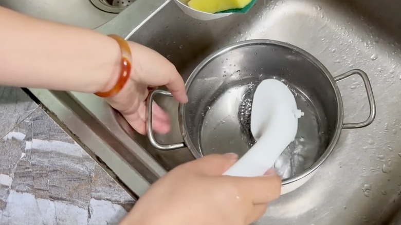 Dish wand made from steel wool and detergent bottle
