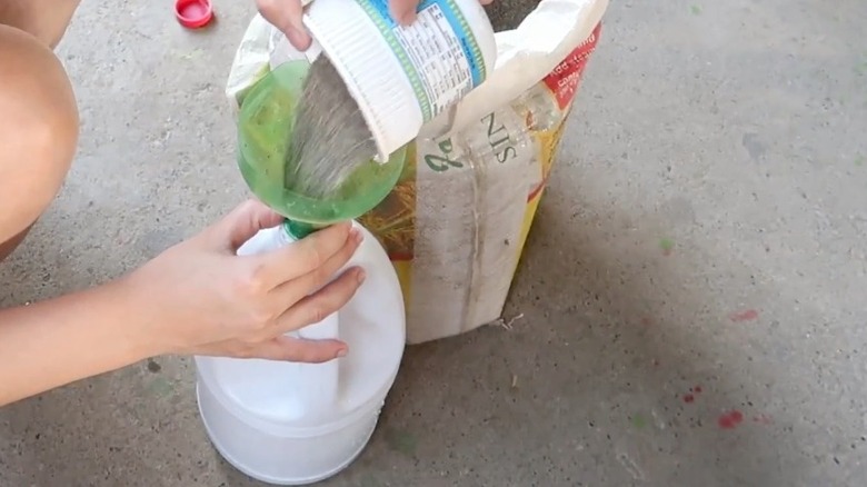 Filling a bottle with material to use as a weight