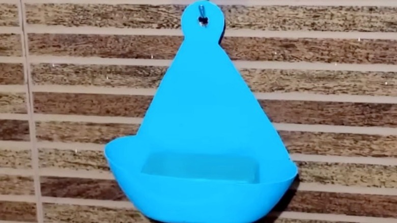 Hanging soap holder made from a detergent bottle