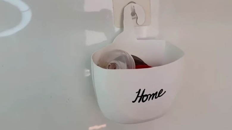 Hanging storage bucket from laundry detergent bottle