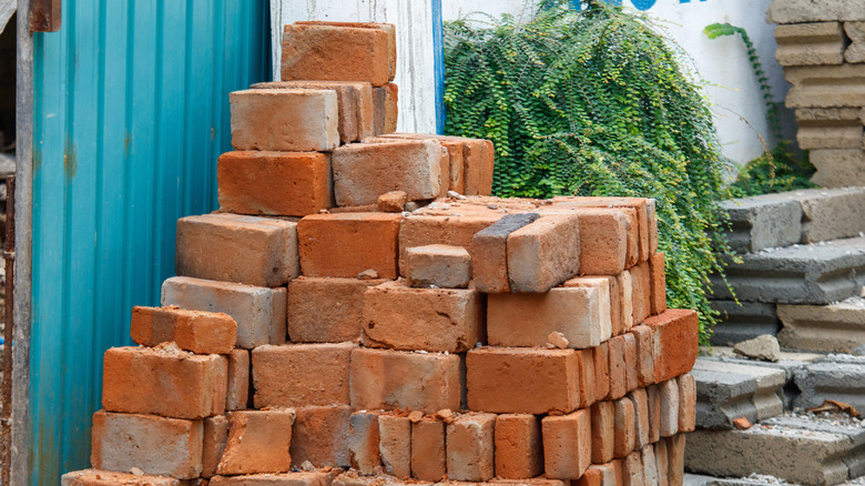 A stack of old red bricks outside