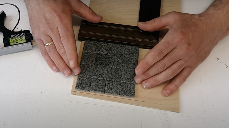 person DIYing tile coaster