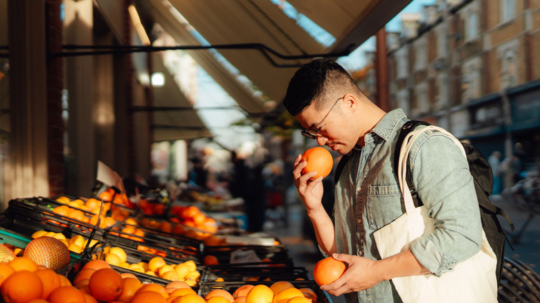 Man shopping for produce at street market