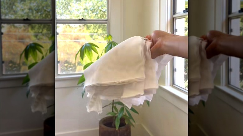 Hand holding DIY towels made from old bed sheet