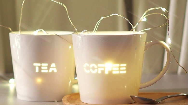 Fairy lights inside white mugs