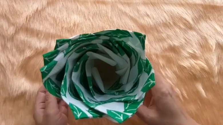 Green and white napkins inside a coffee mug