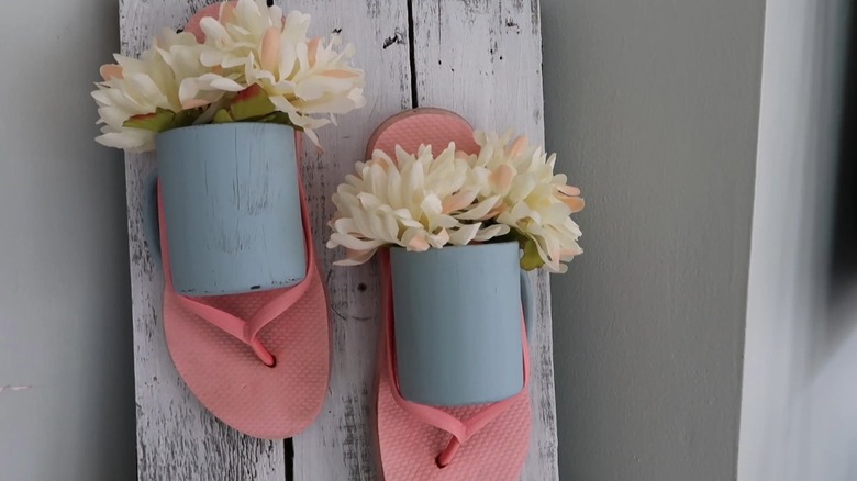 Flowers inside a coffee mug and slipper decor