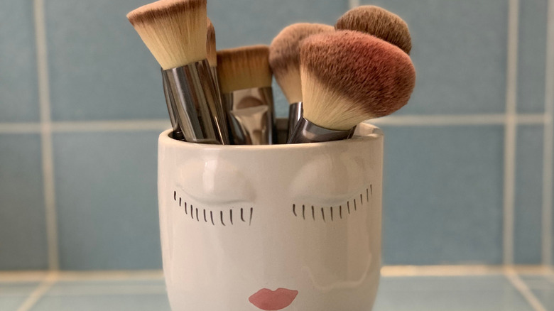 Makeup brushes placed inside a coffee mug