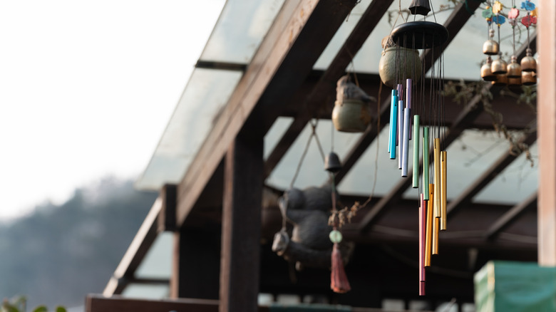 row of hanging wind chimes made from different materials