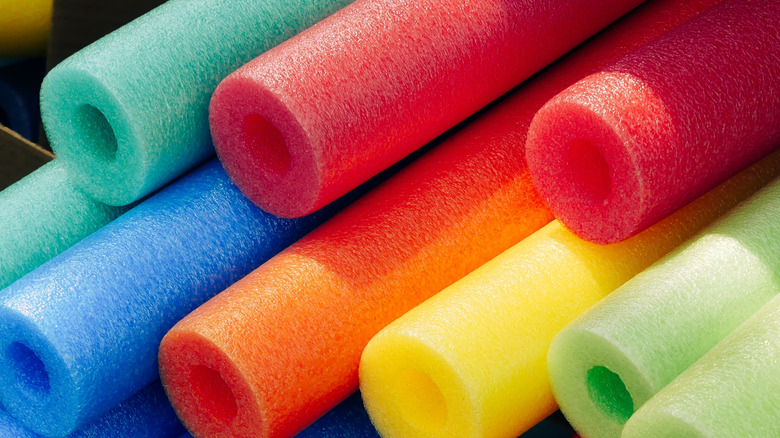 a stack of colorful pool noodles