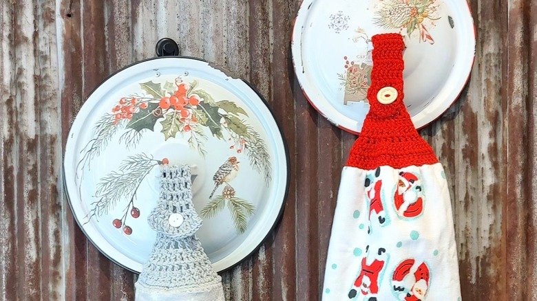 Christmas decorated pan lids holding towels.