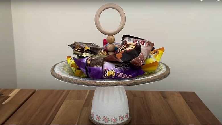 A white and twine tray holding snacks on a table.