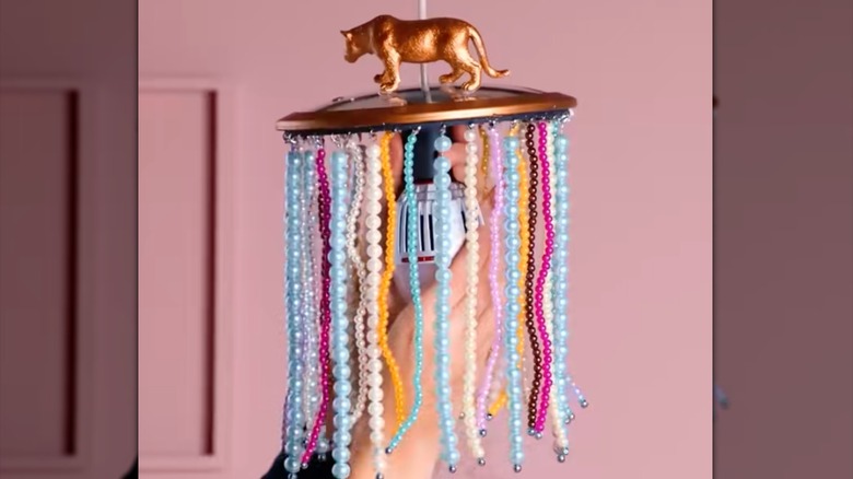 Handing pan lid light with beads hanging off of it.