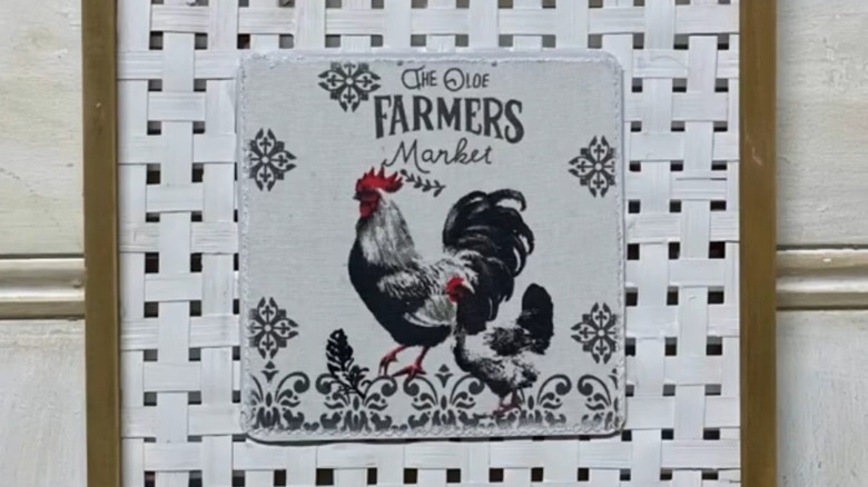 Decoupaged art with a tea towel hanging on a wall