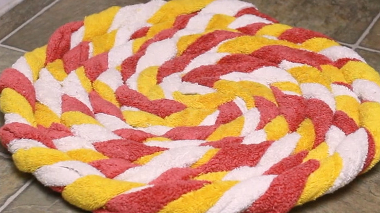 Colorful bath mat made with pink, white, and yellow bath towels
