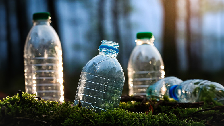 Close up of empty plastic water bottles on on grass