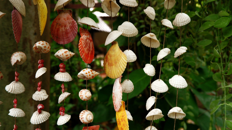 A curtain of seashells hanging in a garden