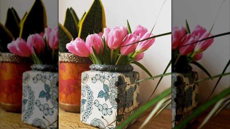 decorated plastic container vases holding flowers