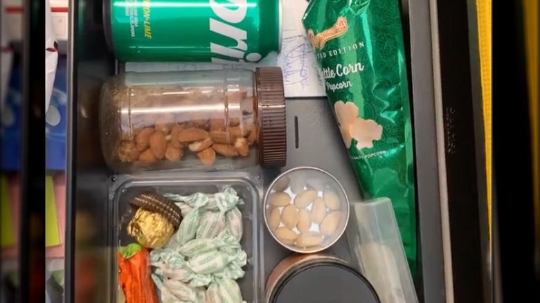 drawer organized with plastic containers and jars holding food