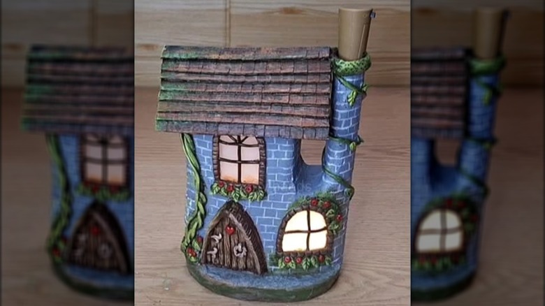 whimshical fairy garden house on table