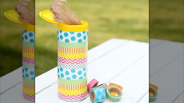 decorated clorox bottle with plastic shopping bag coming out on table