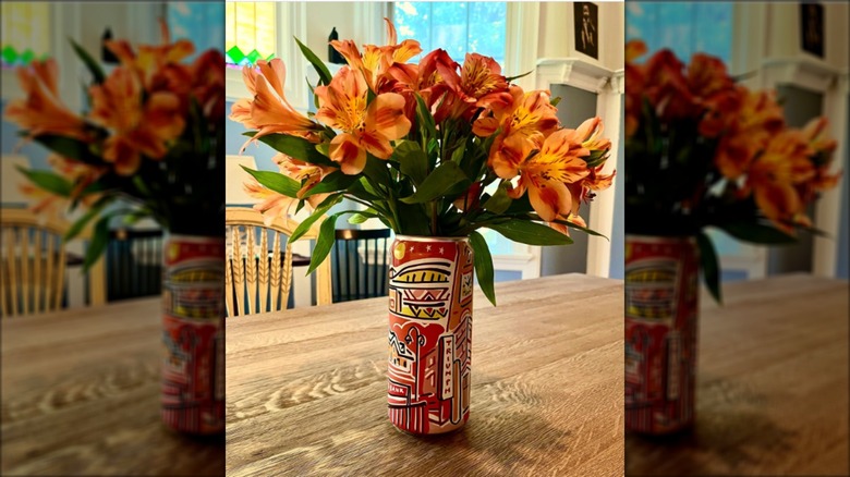 orange flowers in upcycled can vase