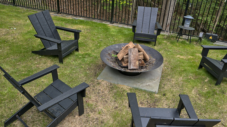 fire pit surrounded by black chairs