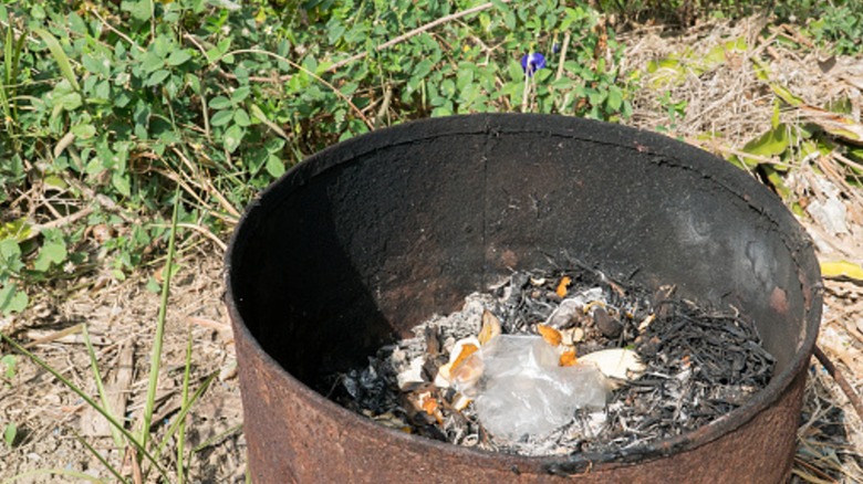fire pit being used as a trash can